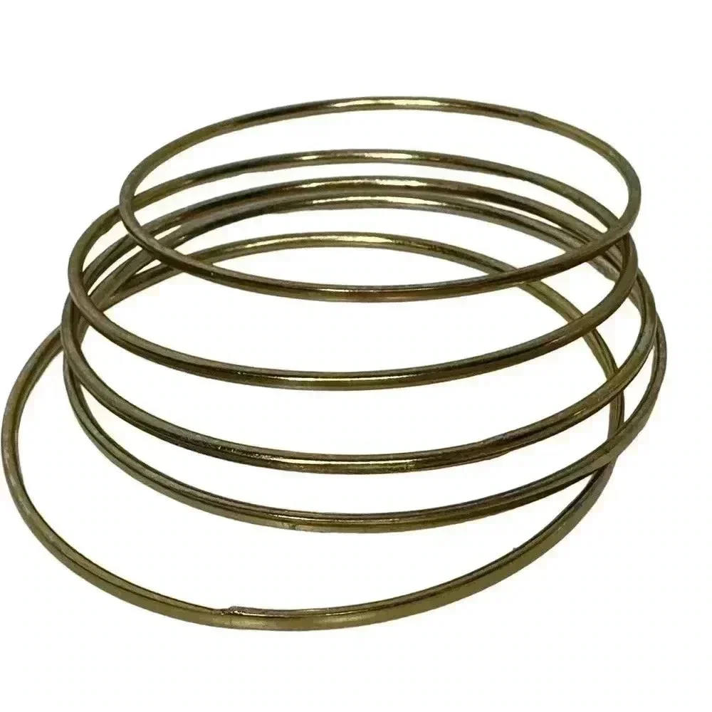 Multiple gold bangle bracelets random assortment of gold colored bracelets